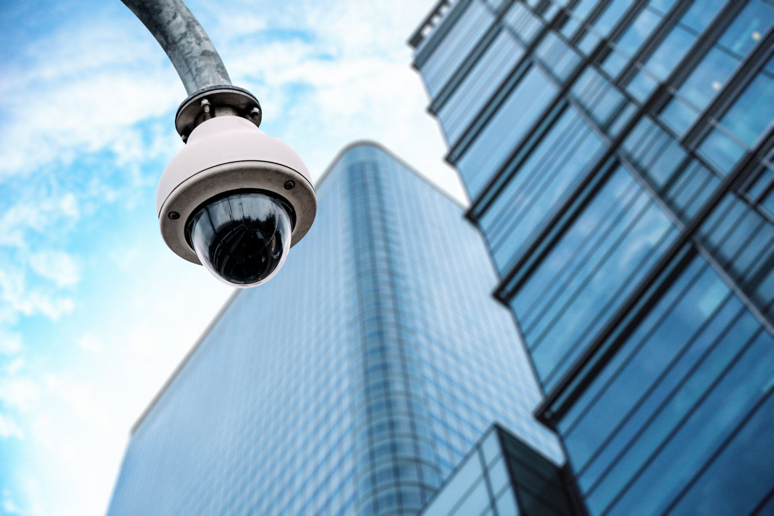 Security camera with a glass building on the background Security camera with a glass building on the background on the street